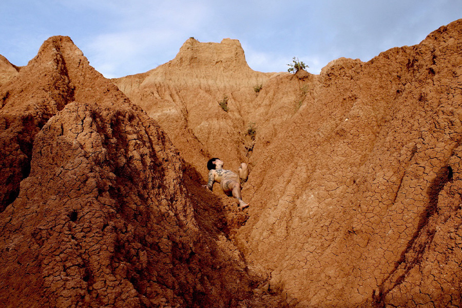Speaker Coyote Park pictured laying across the red clay canyons of Cuzco, Tatacoa.
